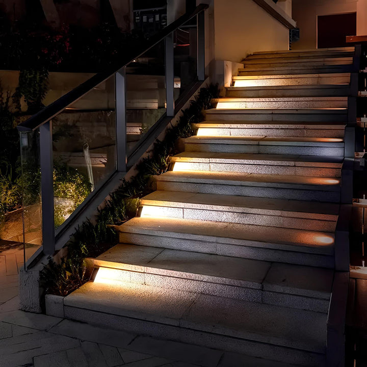 Compact solar light perfectly fitted on stair corner, providing focused dusk-to-dawn illumination for safety.
