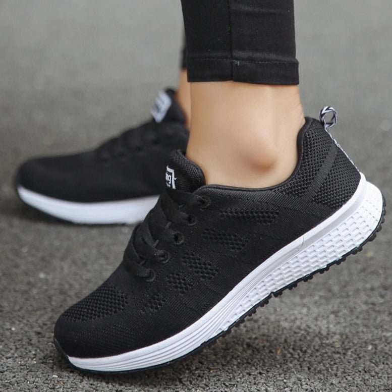 Breathable white women's orthopedic lace-up sneakers, offering lightweight support for daily activities.