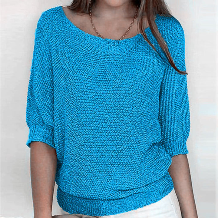 Cozy women's oversized sweater with relaxed batwing sleeves & round neck. Everyday chic winter fashion.