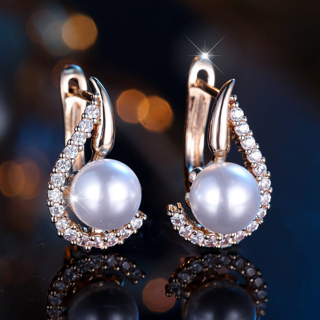 Elegant women's champagne gold pearl & diamond earrings. Classic fashion accessory, perfect for special occasions.
