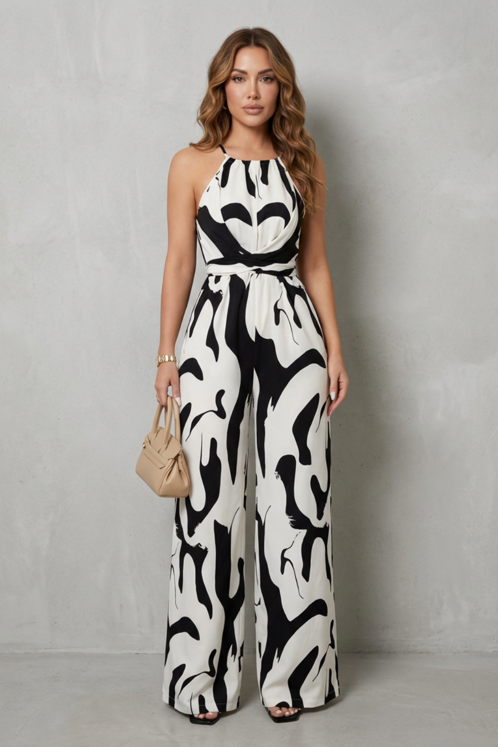 Full-length view of an elegant women's abstract print halter wide-leg jumpsuit, perfect for evening wear.