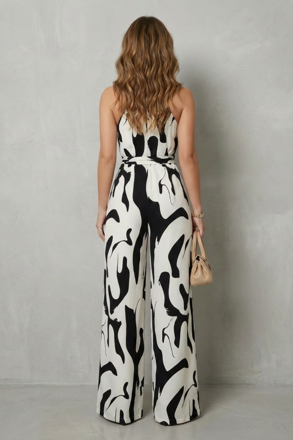Close-up of the vibrant abstract print on an elegant halter wide-leg jumpsuit for women's fashion.