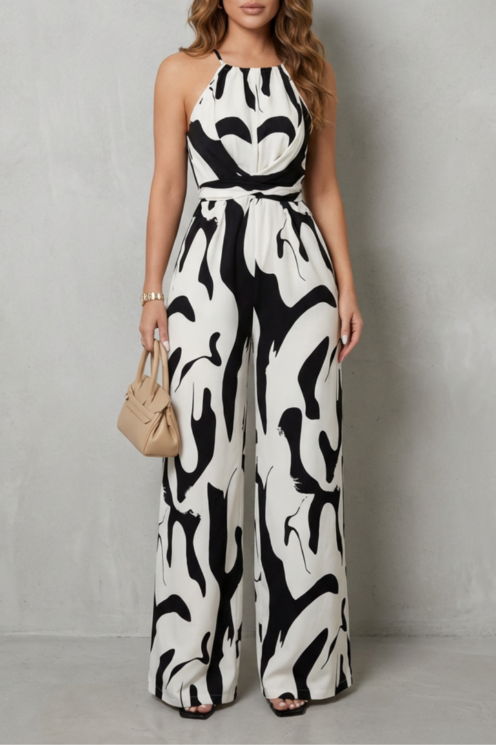 Stylish women's wide-leg jumpsuit with an abstract print and halter neck, ideal for a wedding guest.