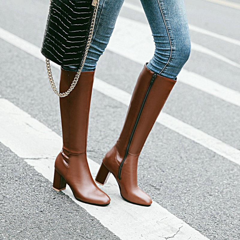 Stylish women's knee-high leather boots with comfortable block heels. Ideal fall & winter fashion footwear.