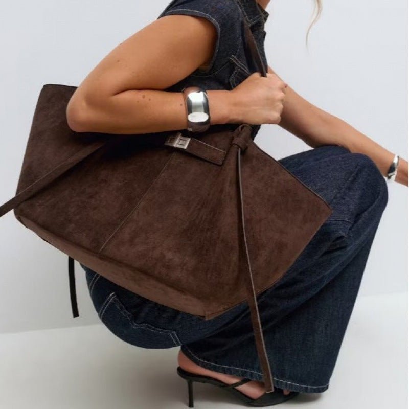 Woman walking with the elegant Verona Structured Shoulder Bag, a chic accessory for urban style.