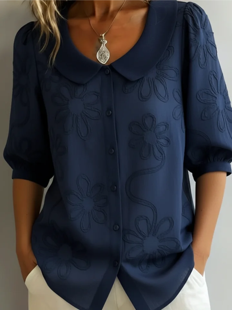 Relaxed fit women's floral embroidered short sleeve blouse. Casual yet elegant round neck top, perfect for versatile summer style.