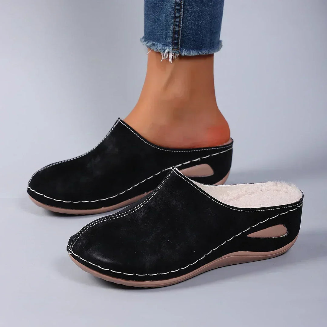 Supportive women's orthopedic slip-on slippers, providing foot relief and ultimate comfort for indoor wear.