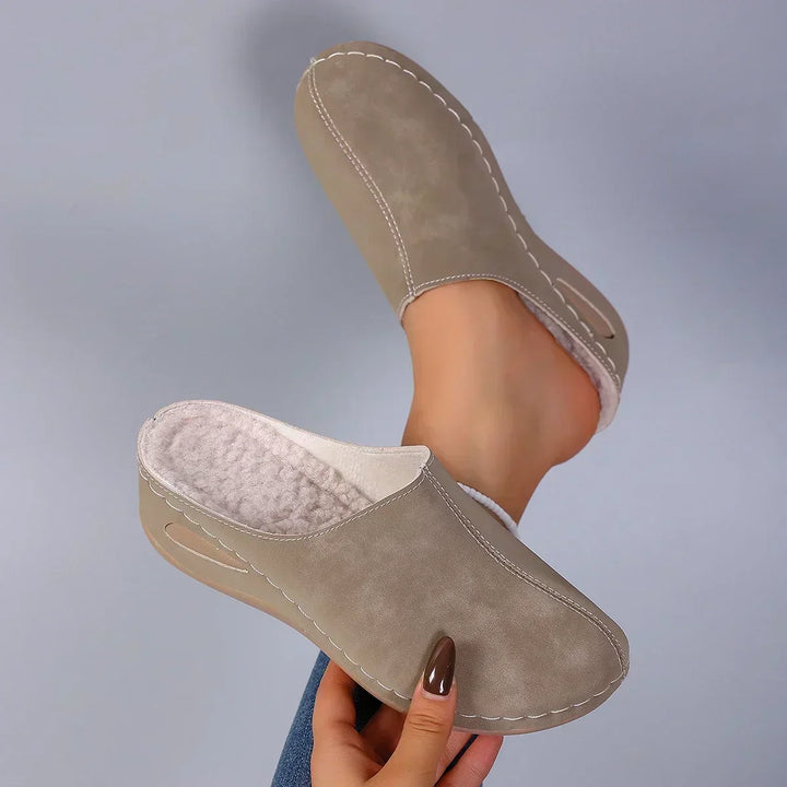 Soft and warm women's slip-on slippers, cushioned for cozy indoor comfort and foot support.