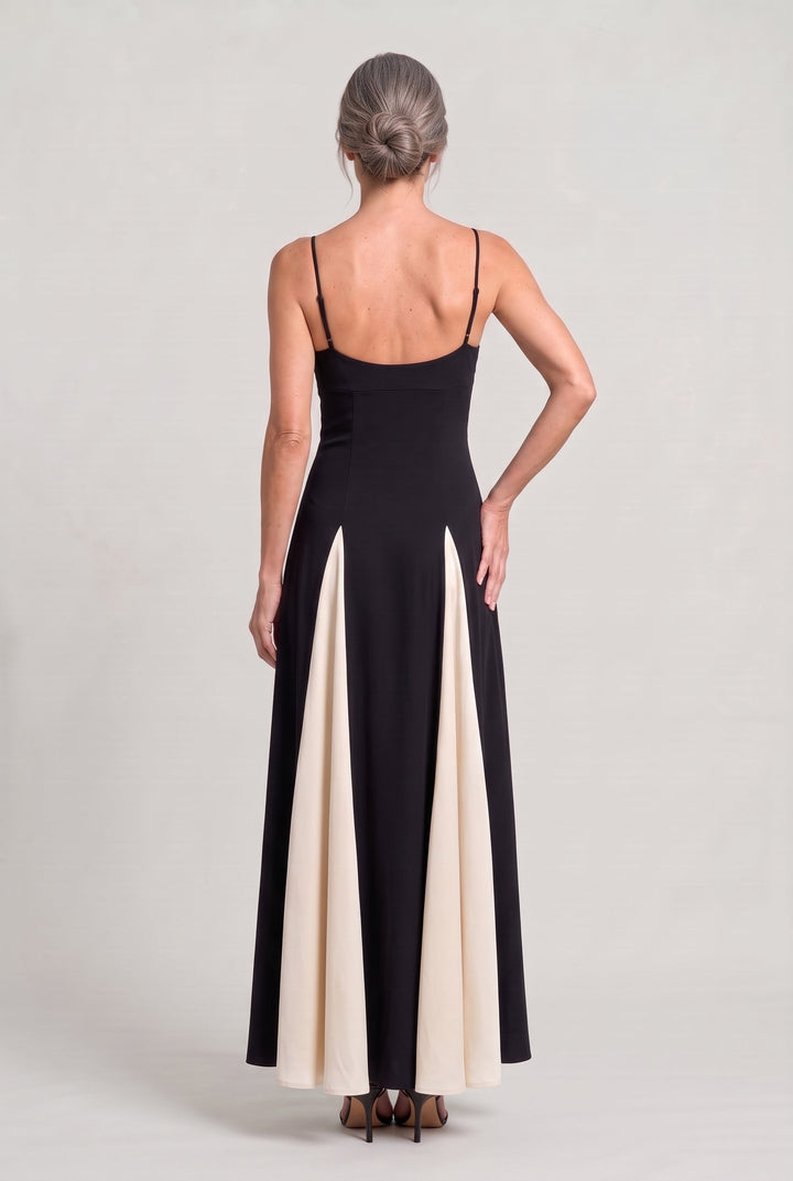 Women's V-neck maxi dress with delicate spaghetti straps, elegant contrast panel & flowing flared skirt design.