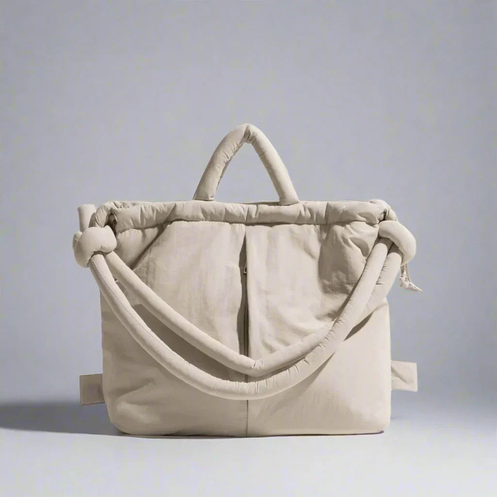 Beige quilted puffer tote bag with soft padding and dual handles