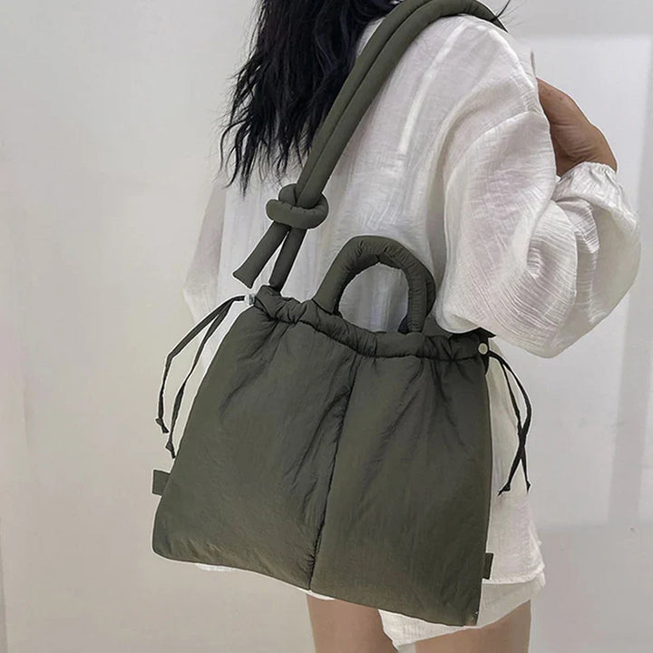Close-up of the beige quilted puffer tote bag showing texture detail