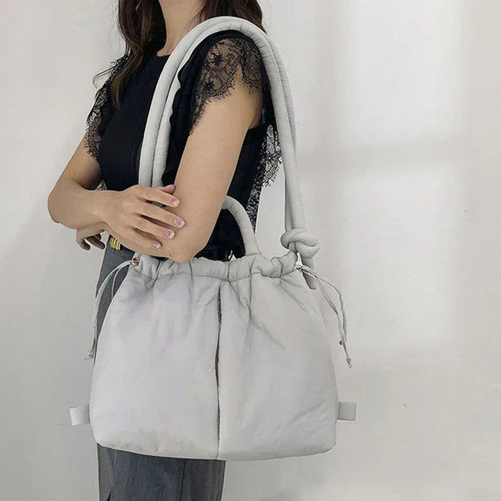 Interior view of the beige puffer tote bag revealing multiple compartments