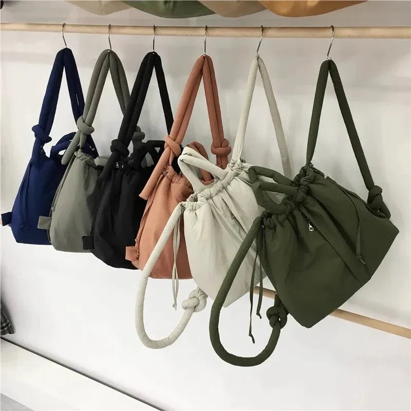 Beige quilted puffer tote bag placed next to everyday items