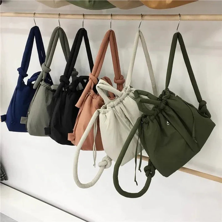 Beige quilted puffer tote bag placed next to everyday items