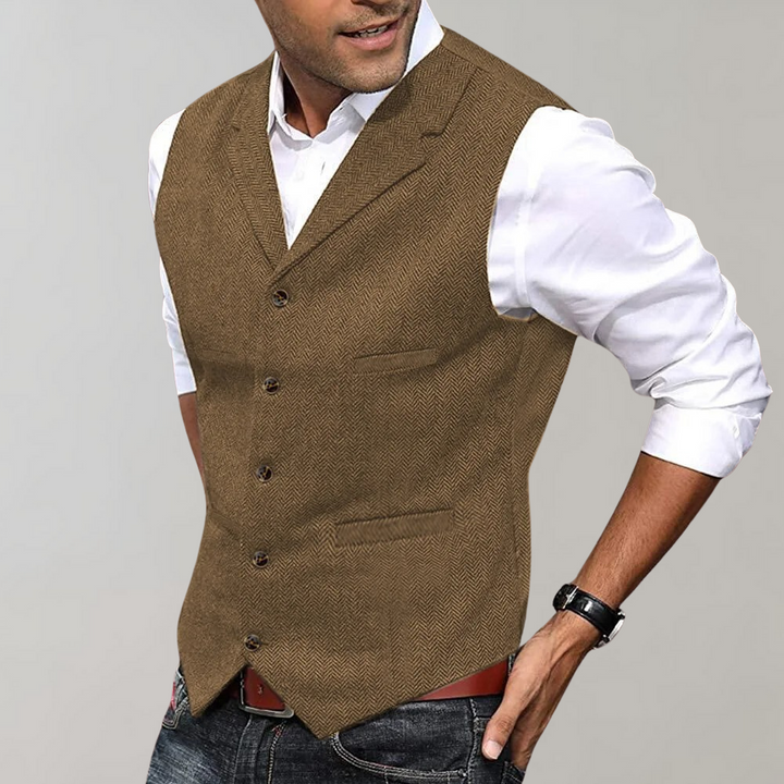 Tailored men's herringbone vest with button-up front. Perfect layering piece for business or wedding attire.