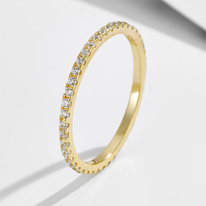 Close-up of a women's sleek copper ring, polished to perfection with a shimmering diamond inlay.
