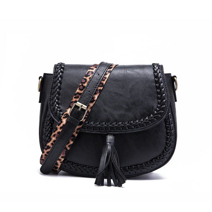 Modern women's faux leather shoulder bag, designed with a fashionable tassel and ample space.