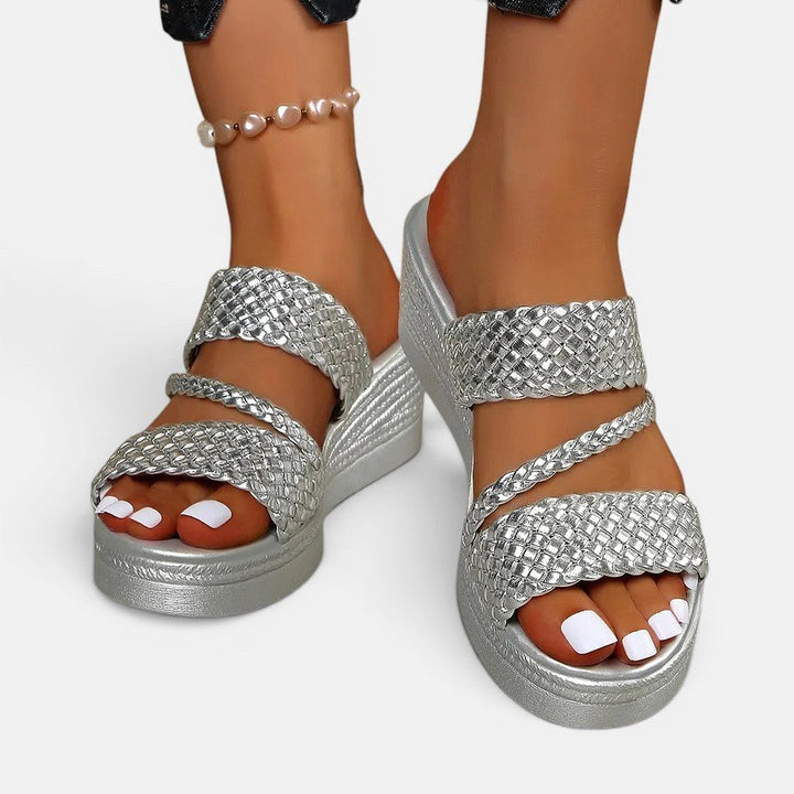 Side view of trendy women's Ainsley platform slip-on sandal, emphasizing height and comfort padding.