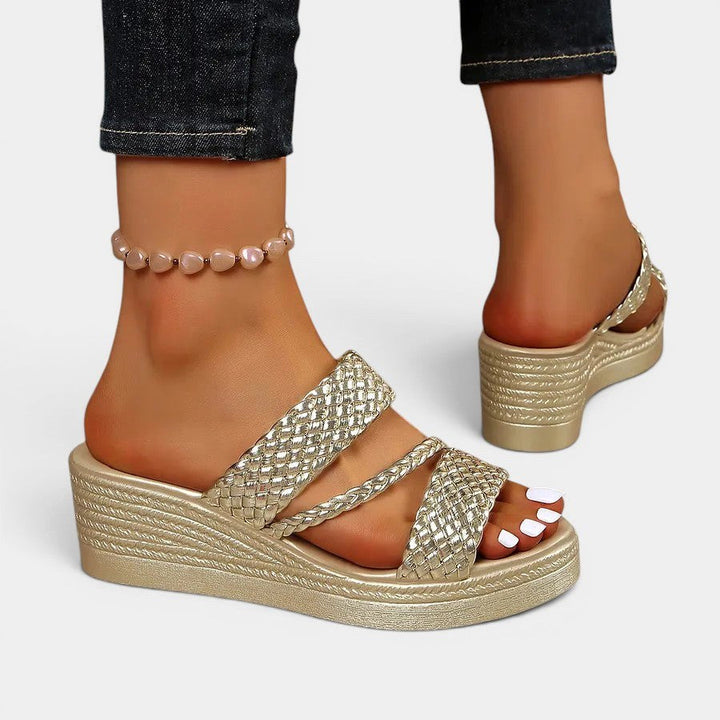 Women's Ainsley slip-on sandals in various colors: black, pink, gold, silver, blue. Padded comfort.