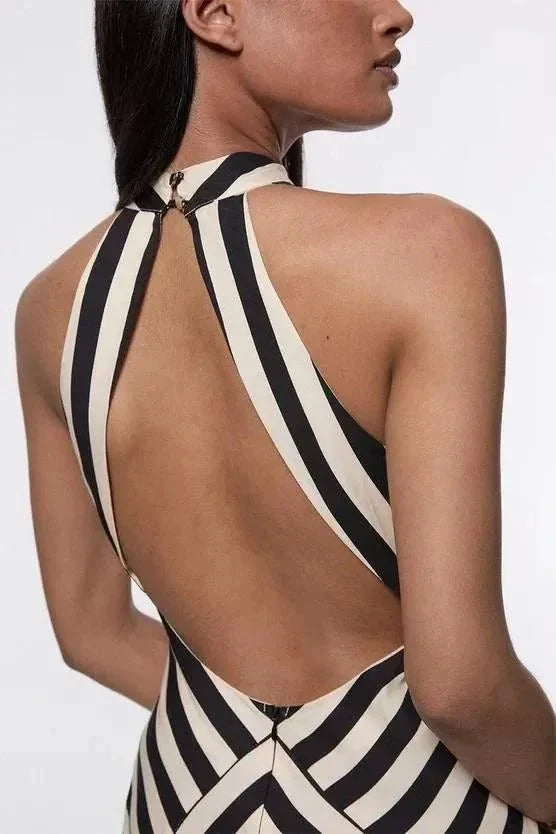 Fashionable women's evening gown with refined chevron stripes, a flattering halter neck, and elegant silhouette.