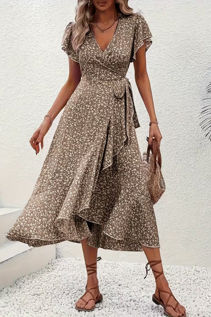Women's refined floral midi wrap dress with v-neck and flutter sleeves, ideal for occasions.