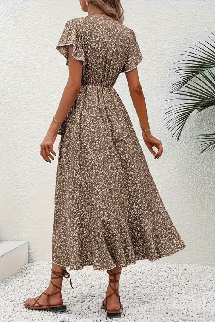 Chic floral print midi dress featuring a wrap style & tiered skirt, suitable for parties.