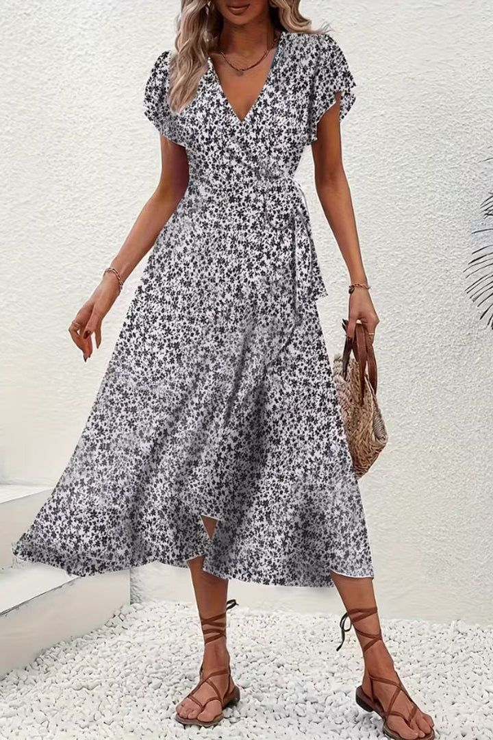 Stylish women's floral wrap midi dress with delicate flutter sleeves & elegant v-neck.
