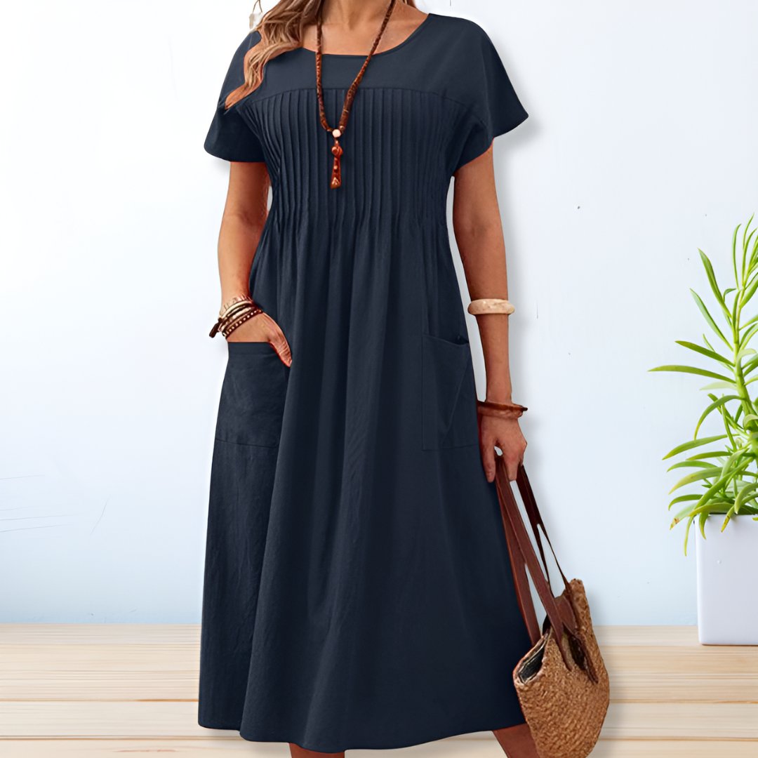 Women's relaxed fit midi dress with short sleeves and practical pockets, perfect for casual summer wear.