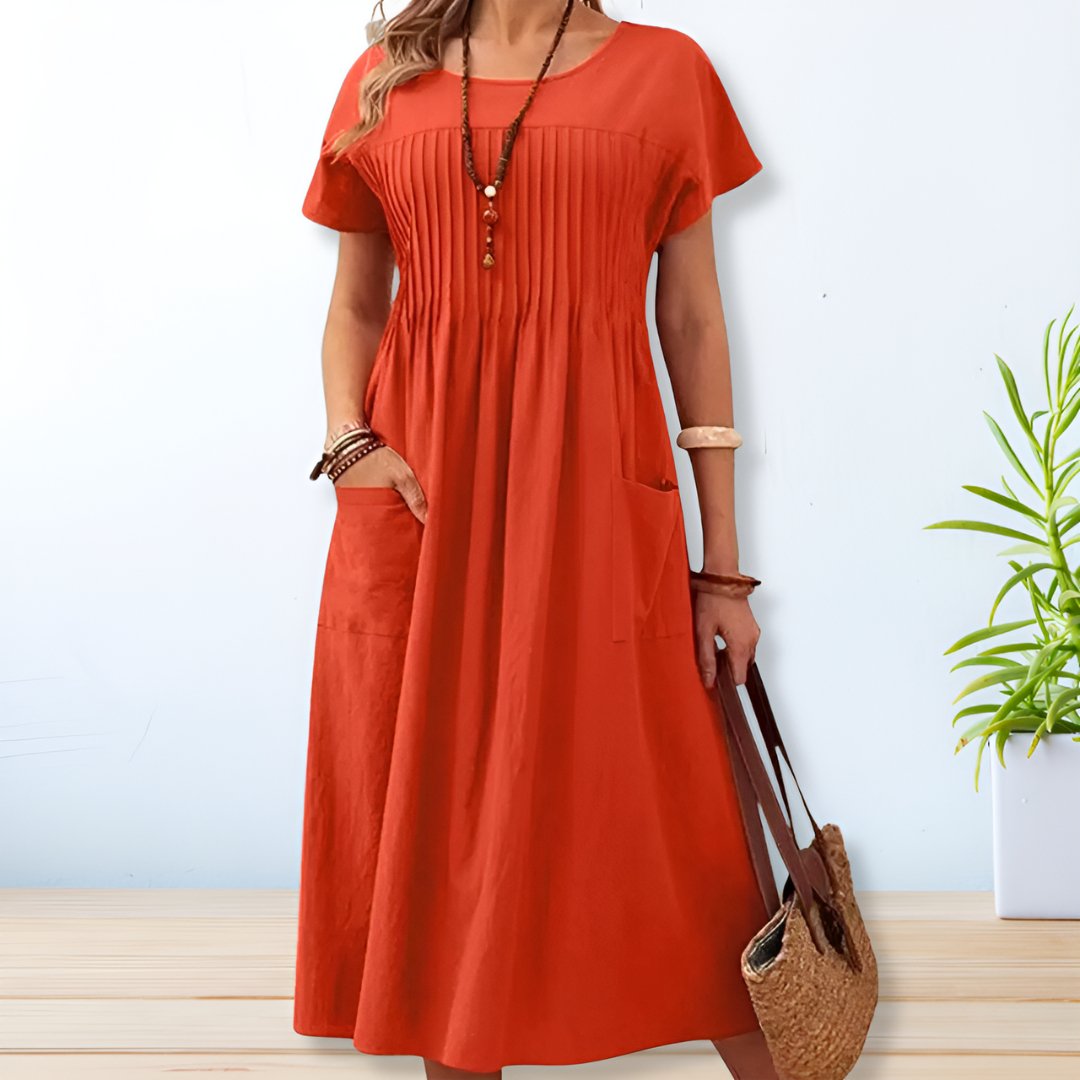 Flowy women's relaxed fit midi dress with short sleeves & pockets, ideal for a comfortable everyday summer look.