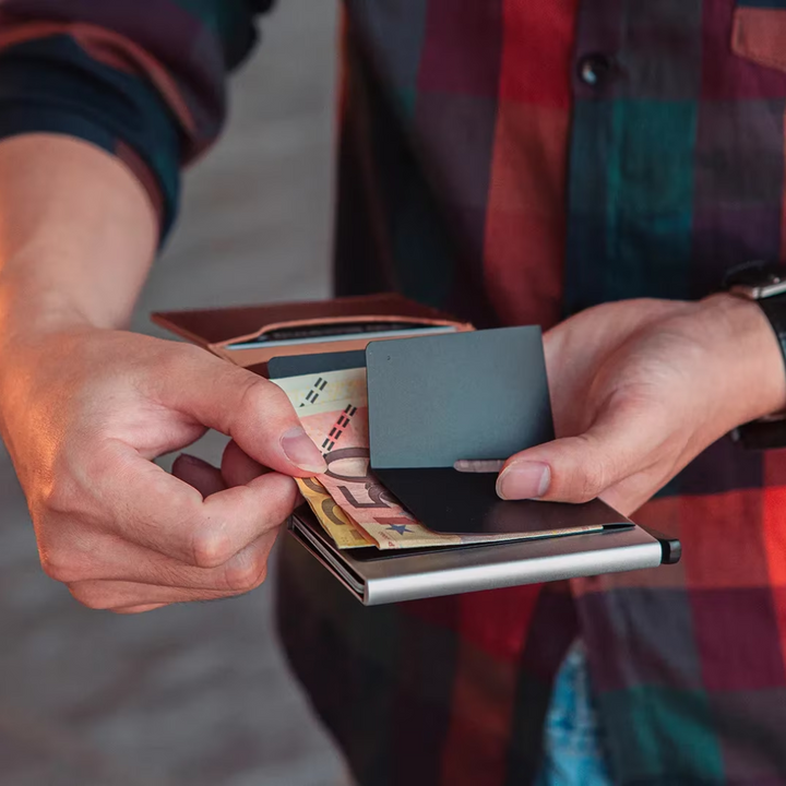 Ultra-slim men's aluminum cardholder wallet with money clip, fitting easily into pockets.