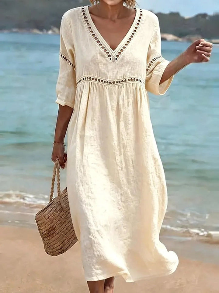 Flowy women's v-neck midi dress in a fluid fabric, ideal for versatile summer fashion and casual day outings.