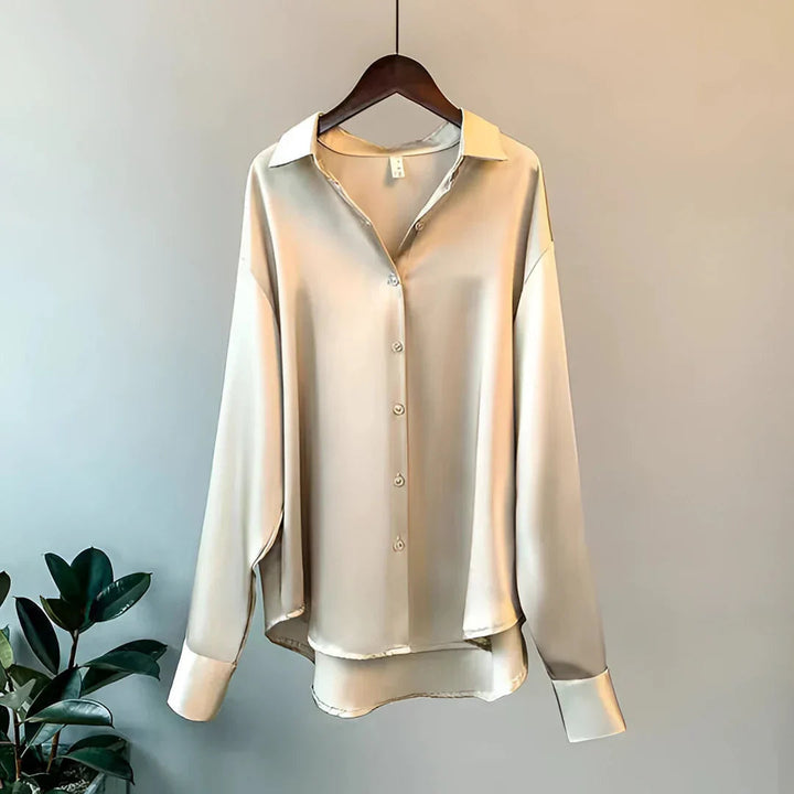 Elegant women's button-up blouse, long sleeve, collared, perfect for office or sophisticated evening wear.