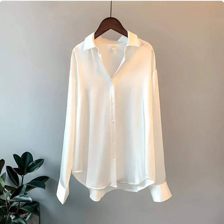 Stylish women's button-up long-sleeve blouse, collared. Elegant office wear, professional top, versatile fashion.