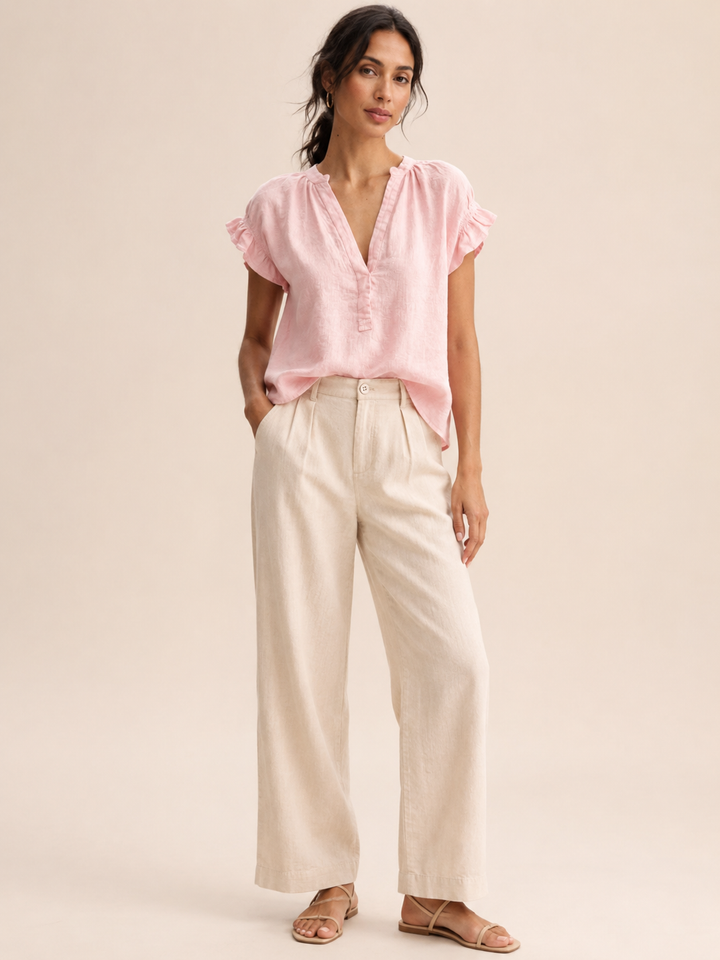 Elegant white women's ruffle sleeve V-neck blouse, offering effortless spring outfit style.