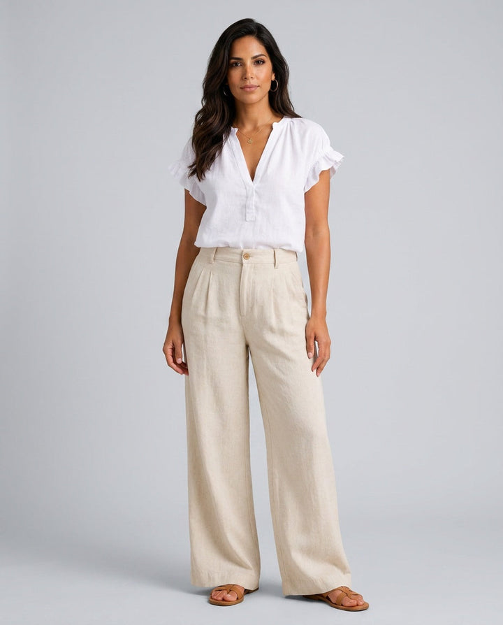 Women's white V-neck top with delicate ruffle cap sleeves, perfect for elegant casual style.