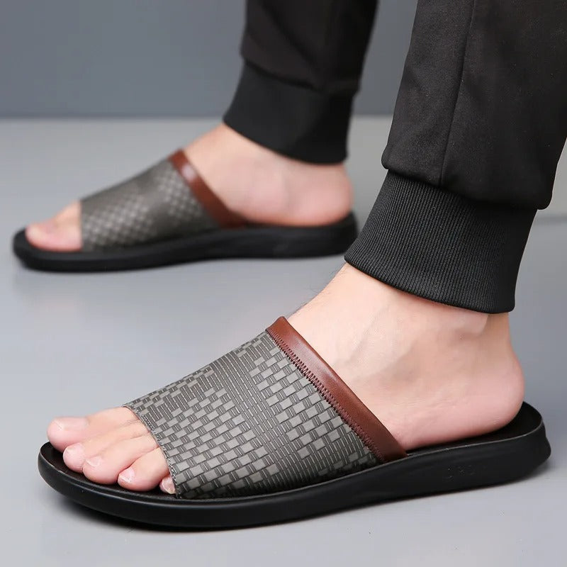 Man wearing comfortable black woven open-toe slip-on slides for a relaxed summer look.