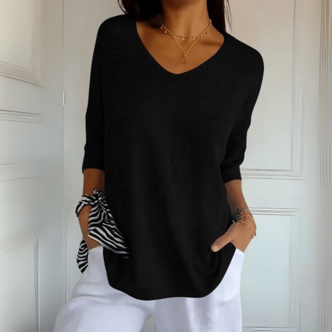 Soft women's three-quarter sleeve v-neck jumper, an essential comfortable top for versatile wear.