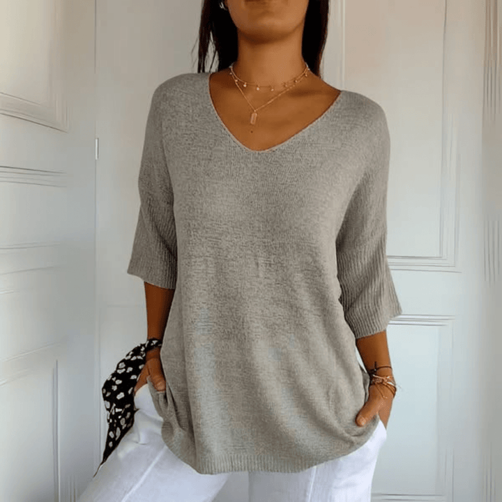 Relaxed women's v-neck knit sweater, a comfortable top with three-quarter sleeves for spring.