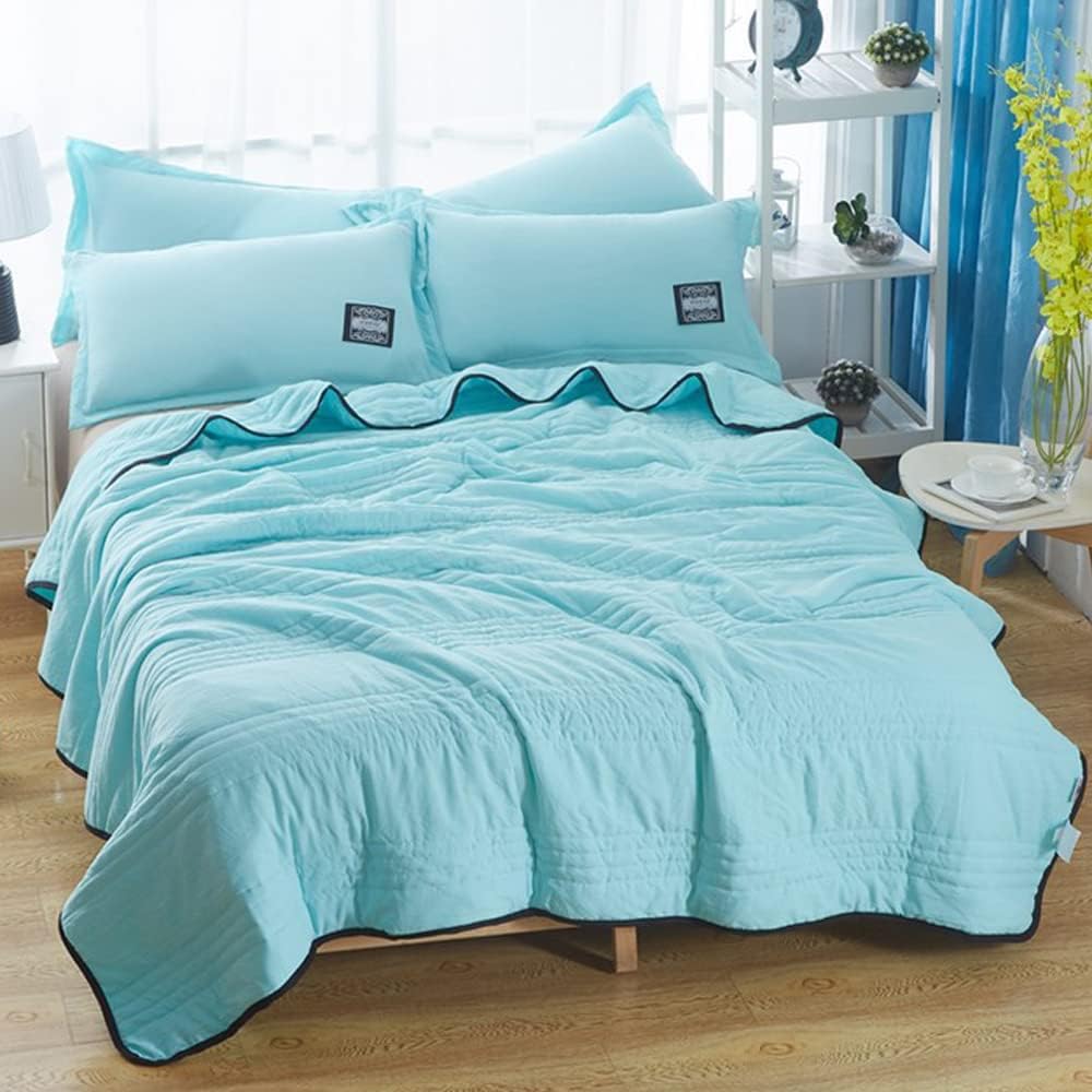 Soft, breathable cooling blanket draped over a bed. Perfect for refreshing sleep & summer comfort.