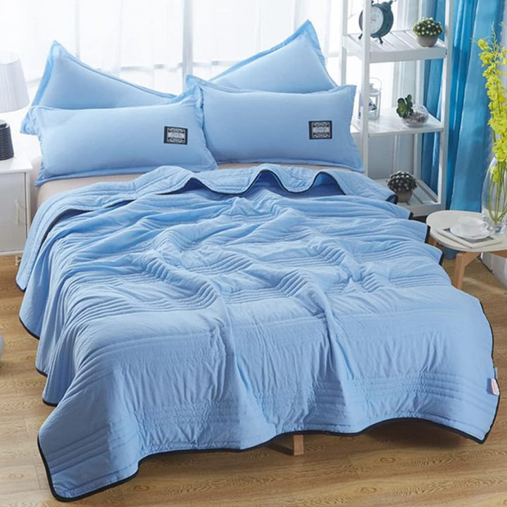 Lightweight cooling throw blanket in a neutral color, ideal for relaxed summer evenings & refreshing sleep.