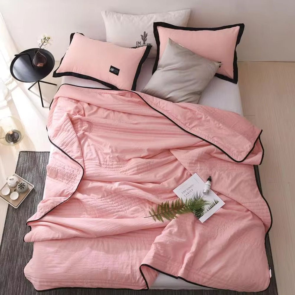Stylish cooling blanket folded neatly on a sofa, adding comfort & modern home decor. Perfect for relaxation.