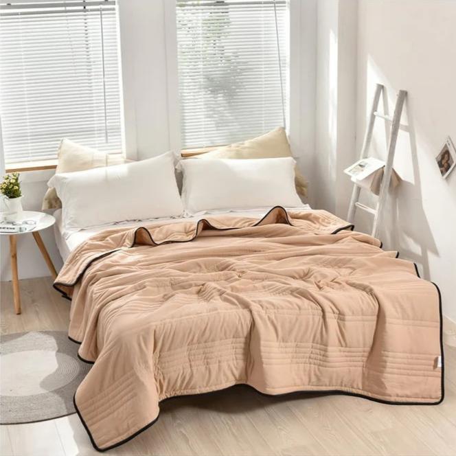 Luxurious cooling comfort blanket draped elegantly, promising refreshing sleep and cozy relaxation.