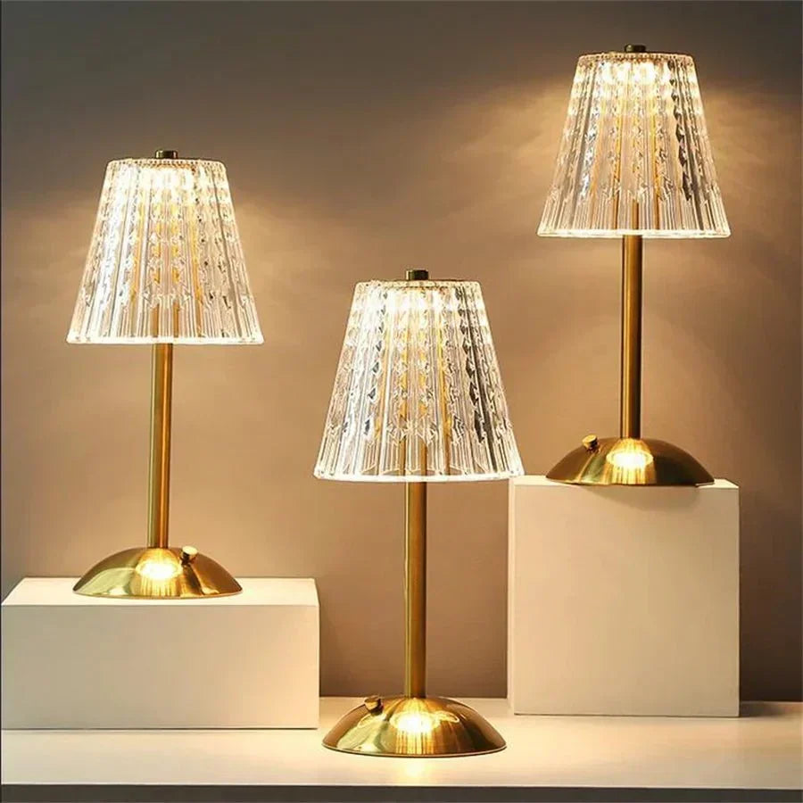Elegant LED crystal table lamp with touch control, gleaming gold base, and ambient light.