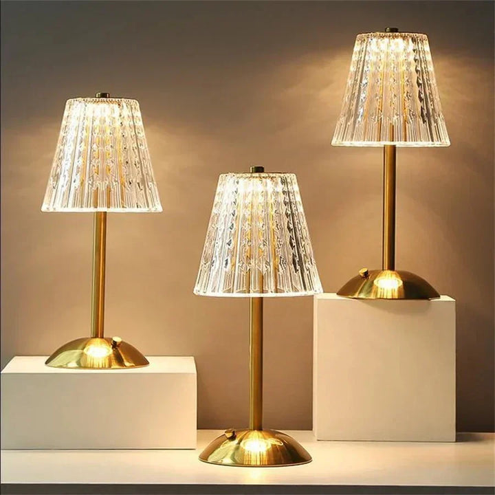 Elegant LED crystal table lamp with touch control, gleaming gold base, and ambient light.