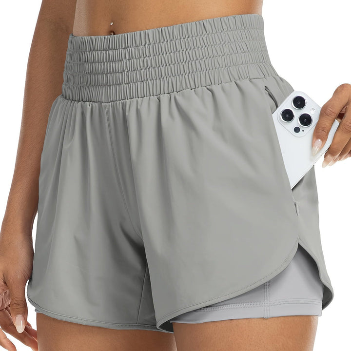 Flexible women's workout bike shorts, high-waisted with dual layers for support.