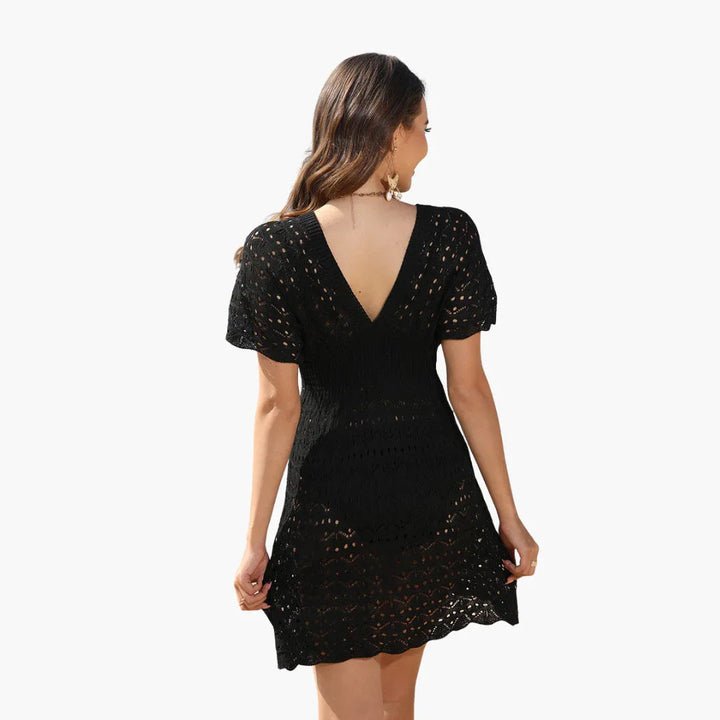 Elegant women's plunge neck crochet beach mini dress, offering a sophisticated look for summer.