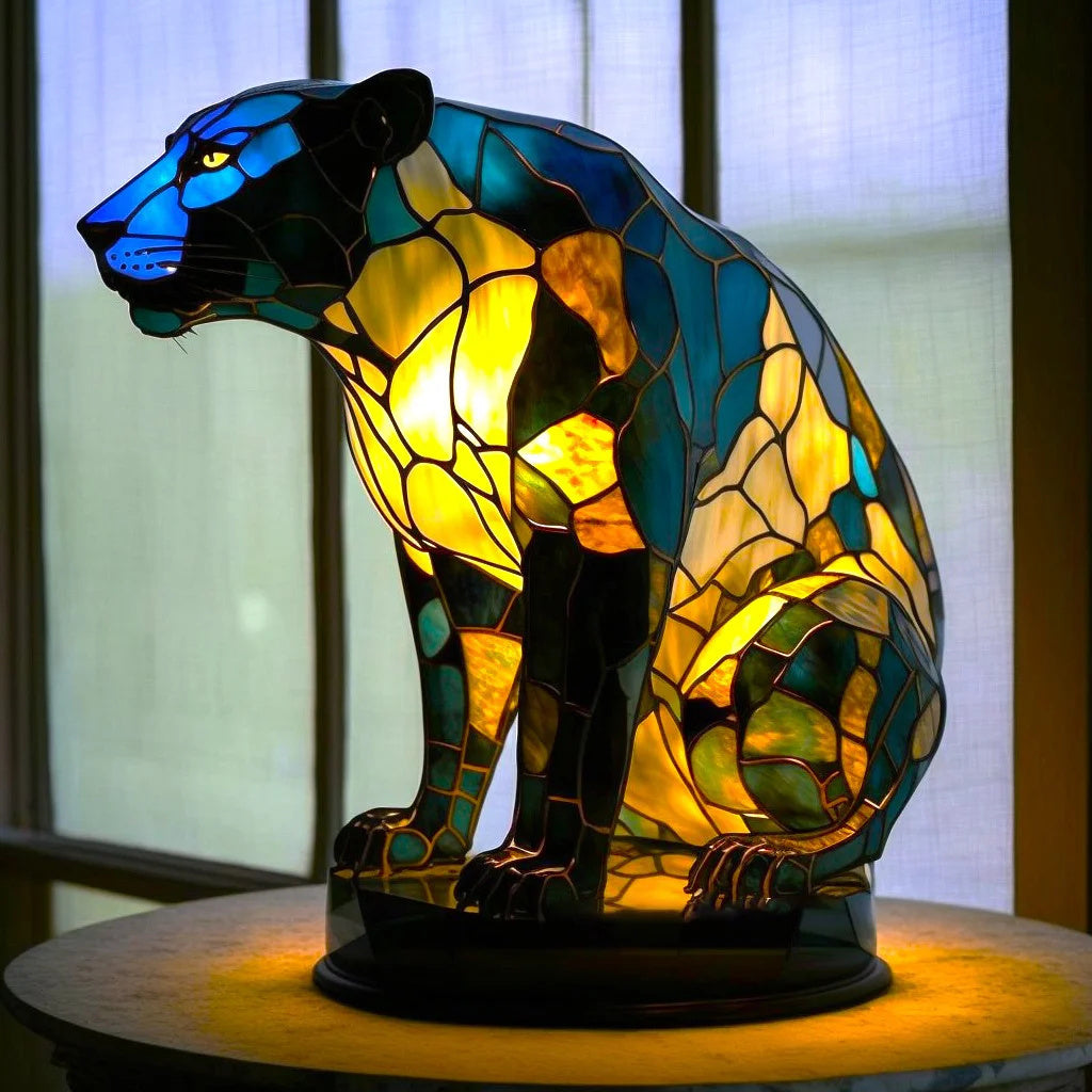 Resin table lamp with an animal motif and a stained glass artistic finish.