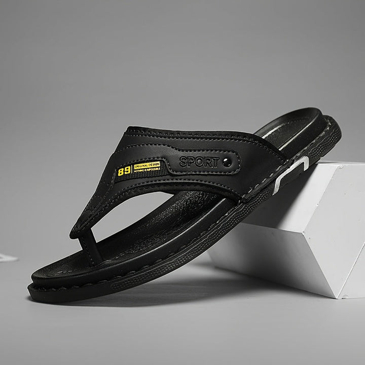 Polished men's non-slip thong sandals, black for stylish summer outings and comfortable beach walks.