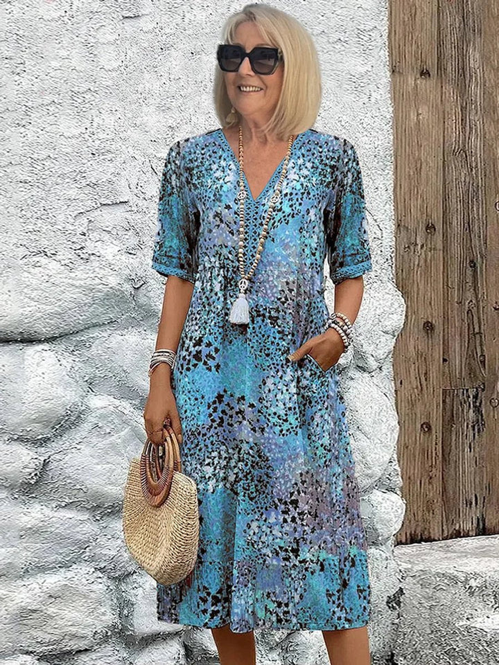 Elegant women's polished floral midi dress with a V-neck and short sleeves, ideal for casual or vacation wear.