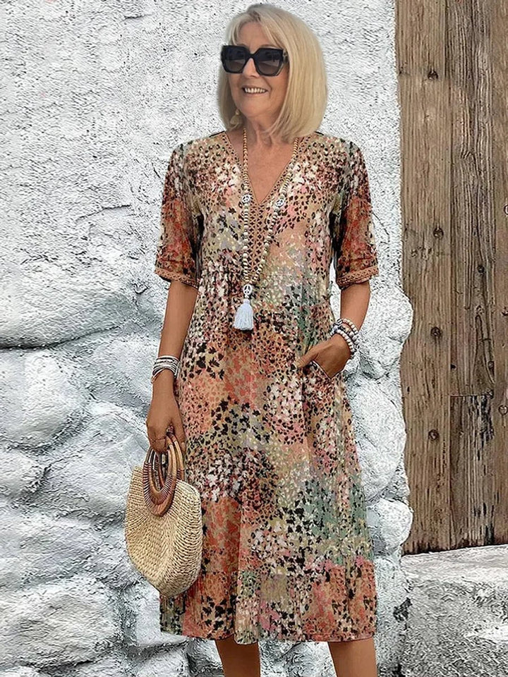 Vibrant floral print V-neck midi dress for women, offering a comfortable, elegant look for casual summer events.